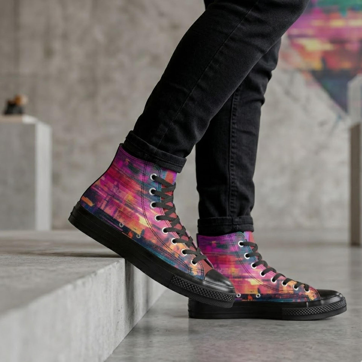 A person wearing black pants and colorful high-top sneakers is standing on a step.