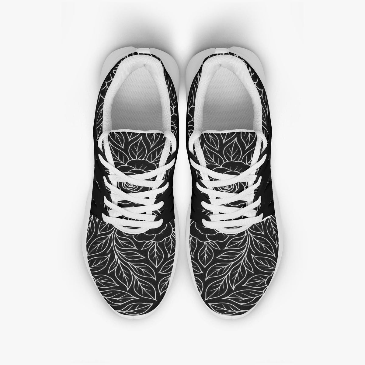 A pair of black and white sneakers with a leaf pattern design.