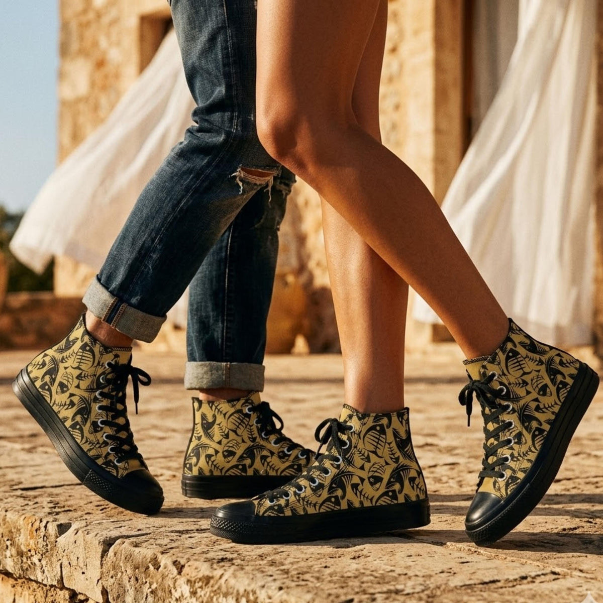 A close-up of two people's legs wearing yellow and black patterned sneakers, with a stone wall and a white curtain in the background.