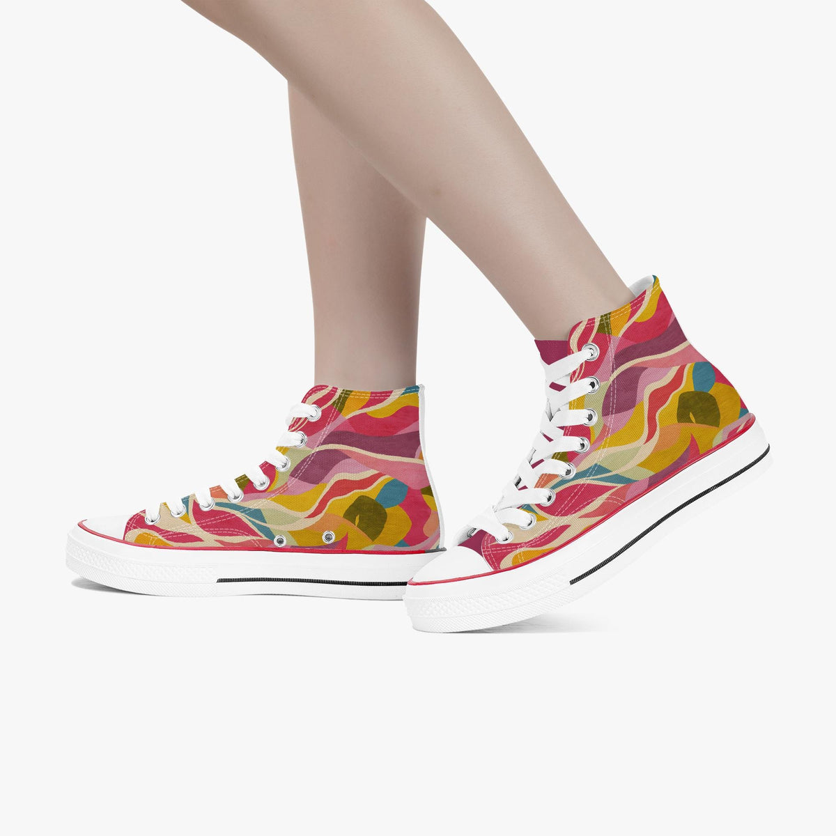 A pair of high-top canvas sneakers with a colorful abstract wavy pattern in pink, yellow, orange, and teal, shown on a model's feet against a light gray background.
