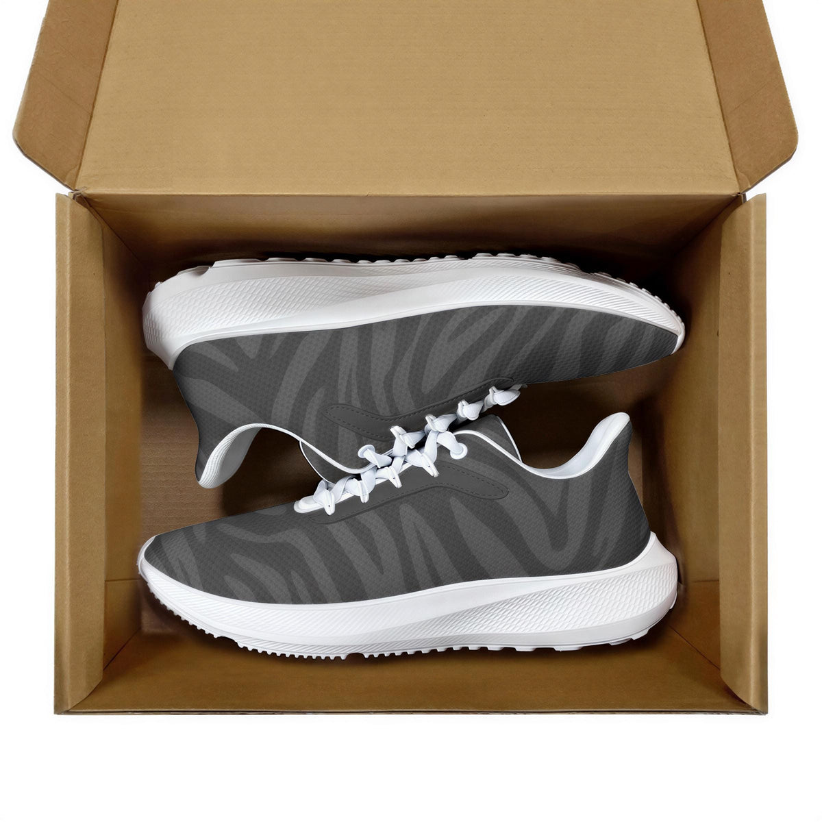 A pair of gray and white sneakers are displayed in an open cardboard box.