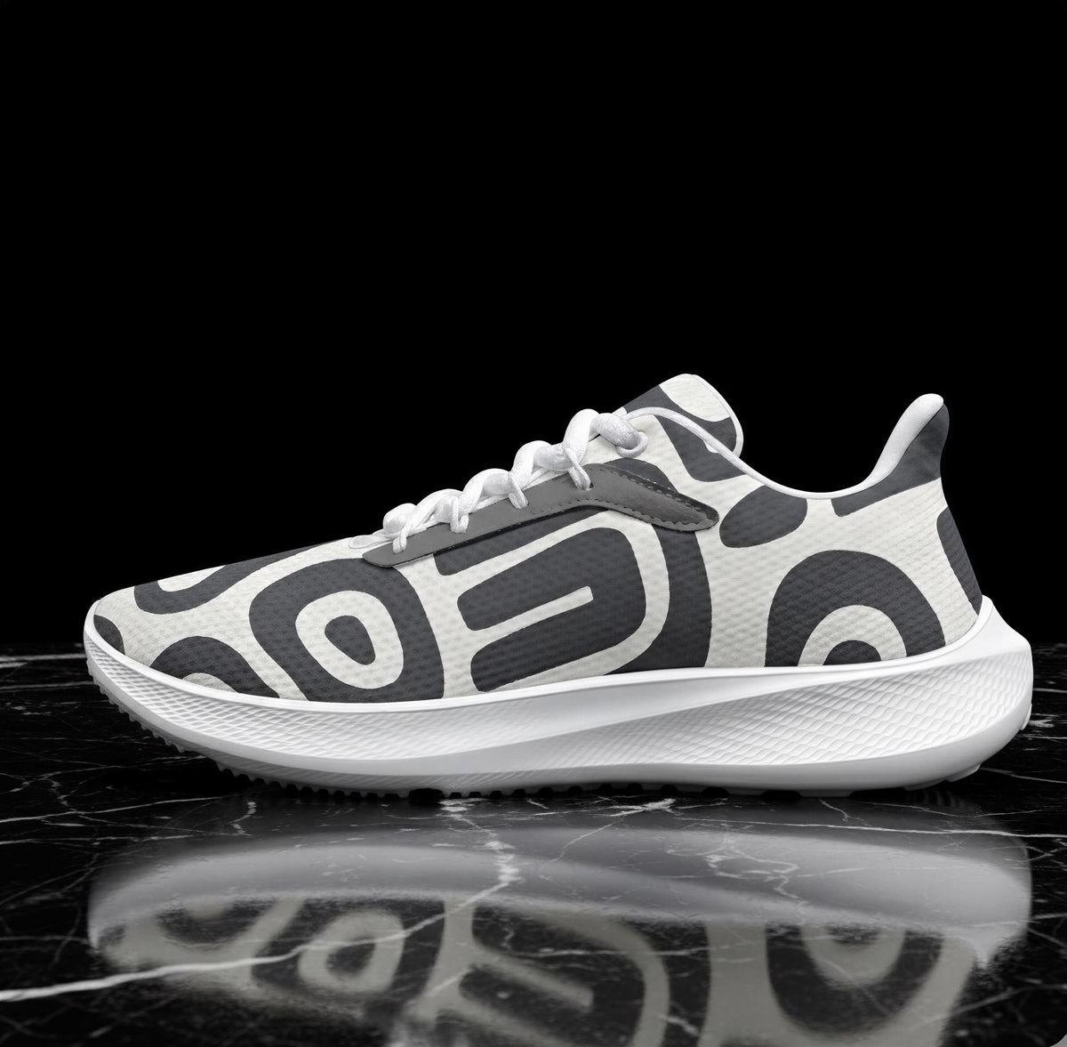 A white and black patterned sneaker is displayed on a black marble surface, reflecting the image.