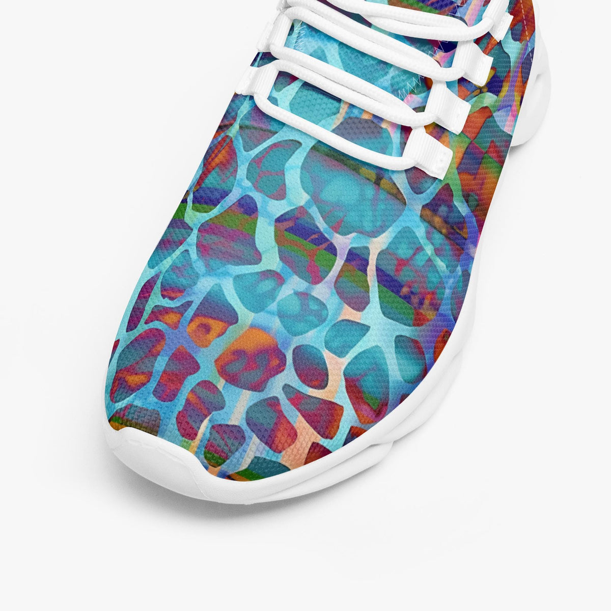 A close-up of a sneaker featuring a vibrant, multicolored abstract pattern with blue, purple, red, and orange shapes outlined in white, with white laces and a white sole.